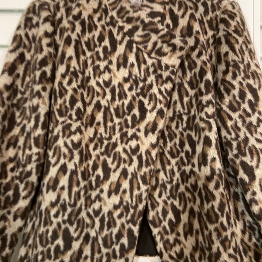 Chico jacket. One botton … hidden across chest.